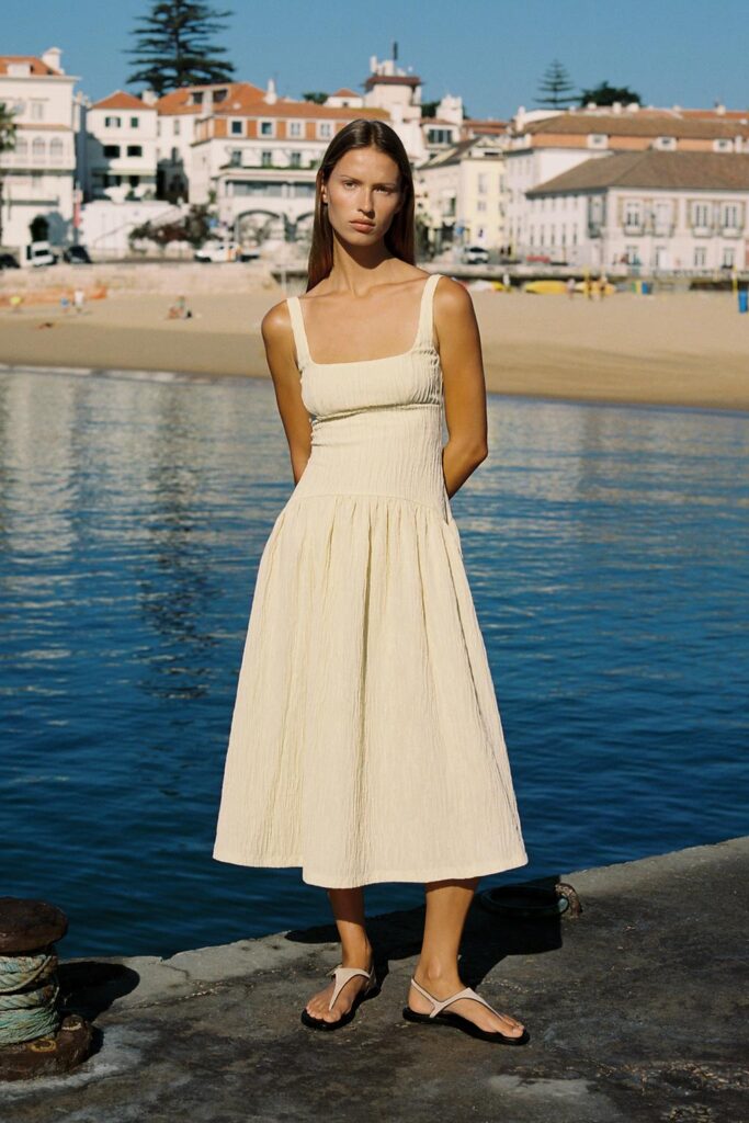 Woman wearing Zara Textured Strappy Dress in light cream – elegant summer Zara dress by the beach