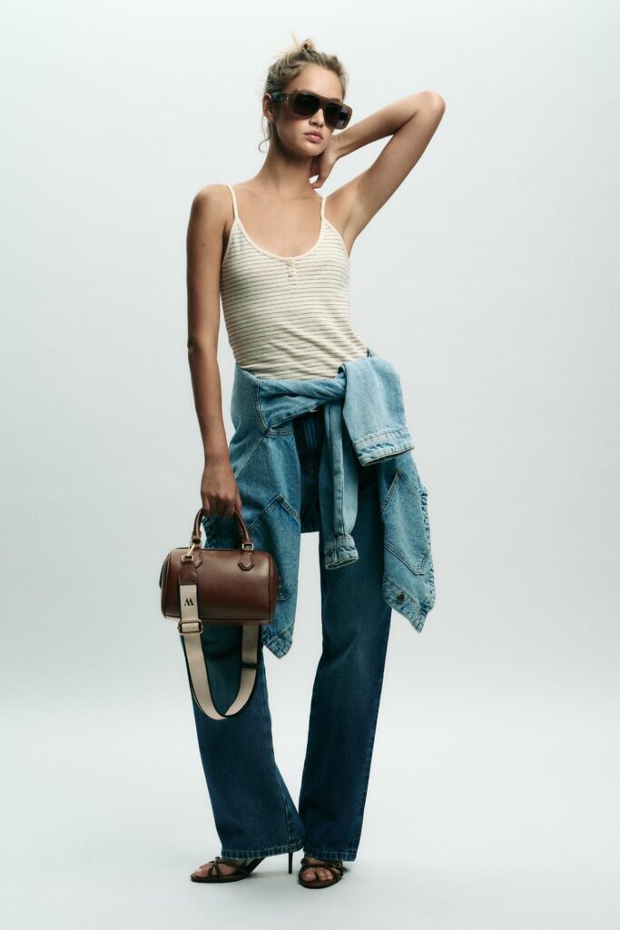 Dark tan handbag set with double handle, removable strap, tank top, denim jacket, and blue pants.