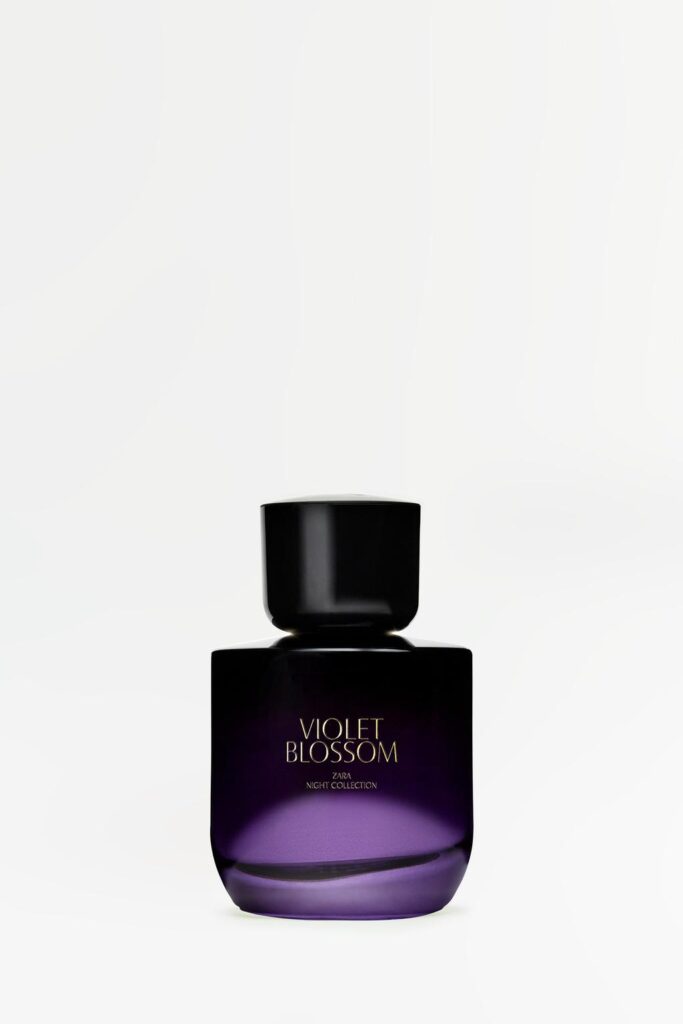 Front view of 'Violet Blossom' perfume bottle with black cap and purple glass.
