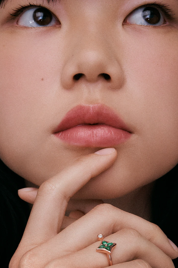 Louise Vuitton Color Blossom Mini Star Ring on a cute woman's finger, and it's touching the face