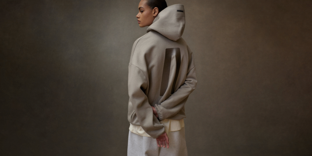 Woman wearing a minimalist oversized hoodie from Fear of God, photographed from the back.