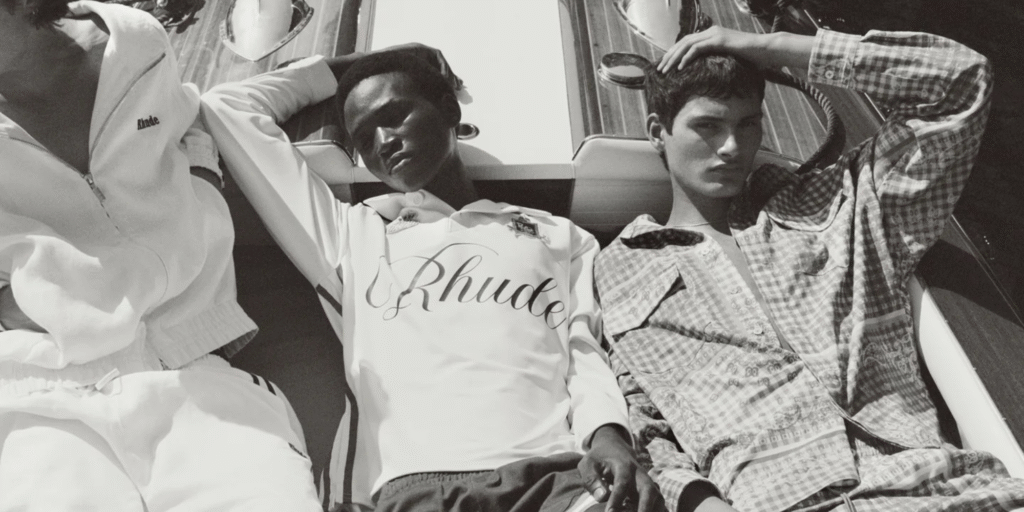 Three models wearing Rhude clothing, lounging casually on a yacht in a black-and-white fashion editorial.
