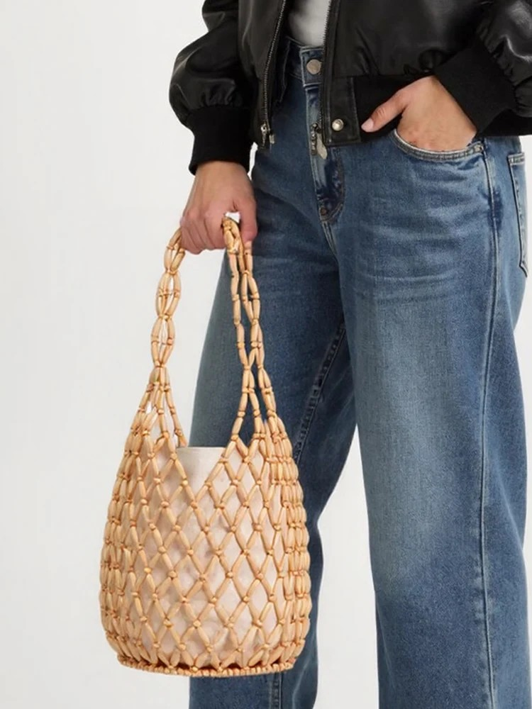 Handcrafted woven handbag made from eco-friendly maple beads, featuring a cotton-linen lining and a detachable inner pouch with a drawstring closure.