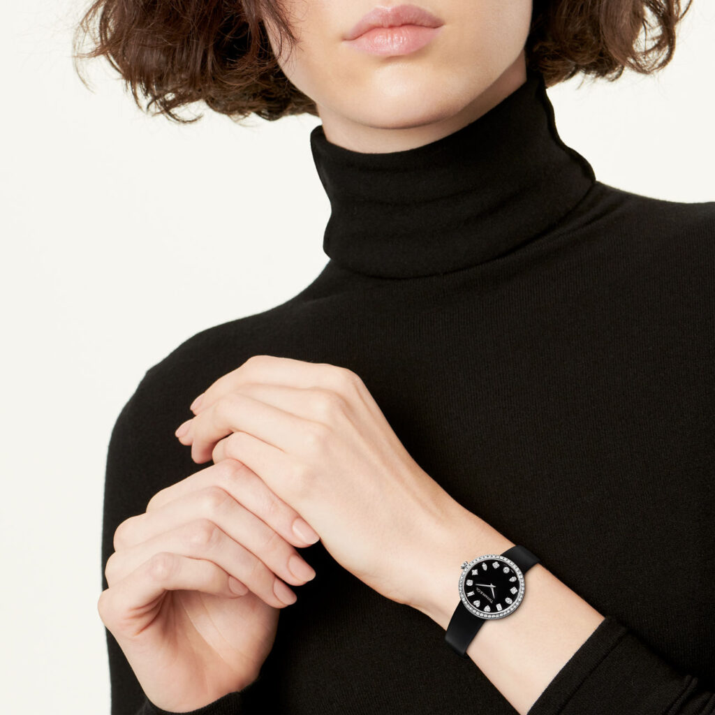 Women Wearing Black Tiffany & Co Eternity Watch with Black Belt and Black Sweatshirt