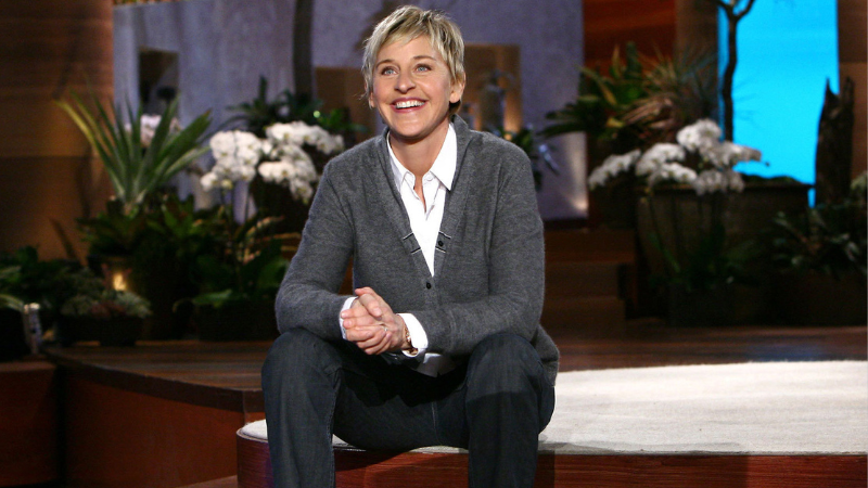 Ellen DeGeneres sitting on studio floor
